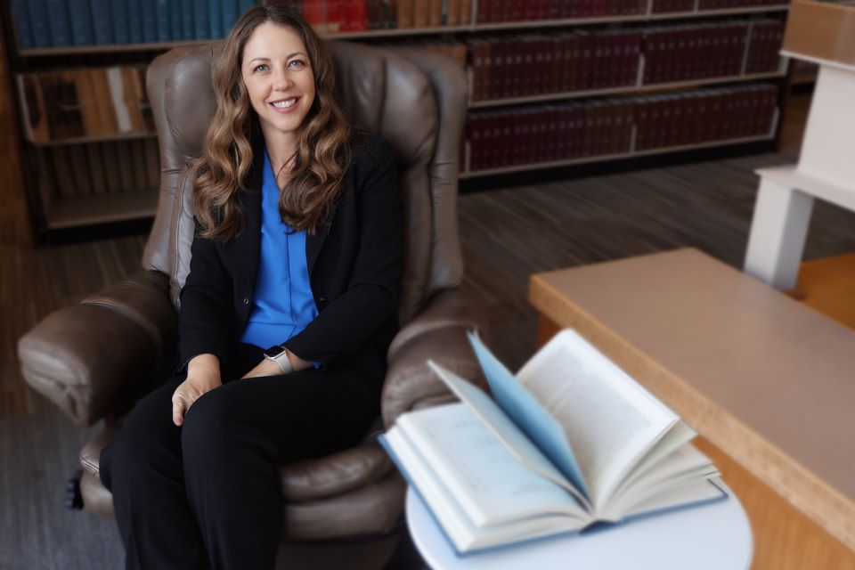 Deborah O'Malley poses in the library at Scott Hall