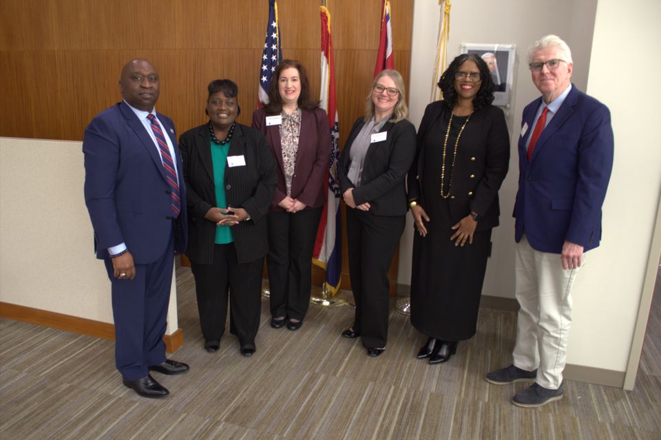 dean twinette johnson poses in the courtroom with panelists from the ai and the law panel