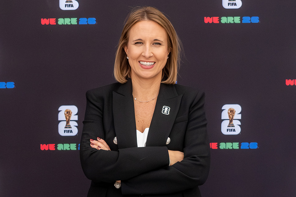 Amy Hopfinger Amy Hopfinger in front of FIFA backdrop